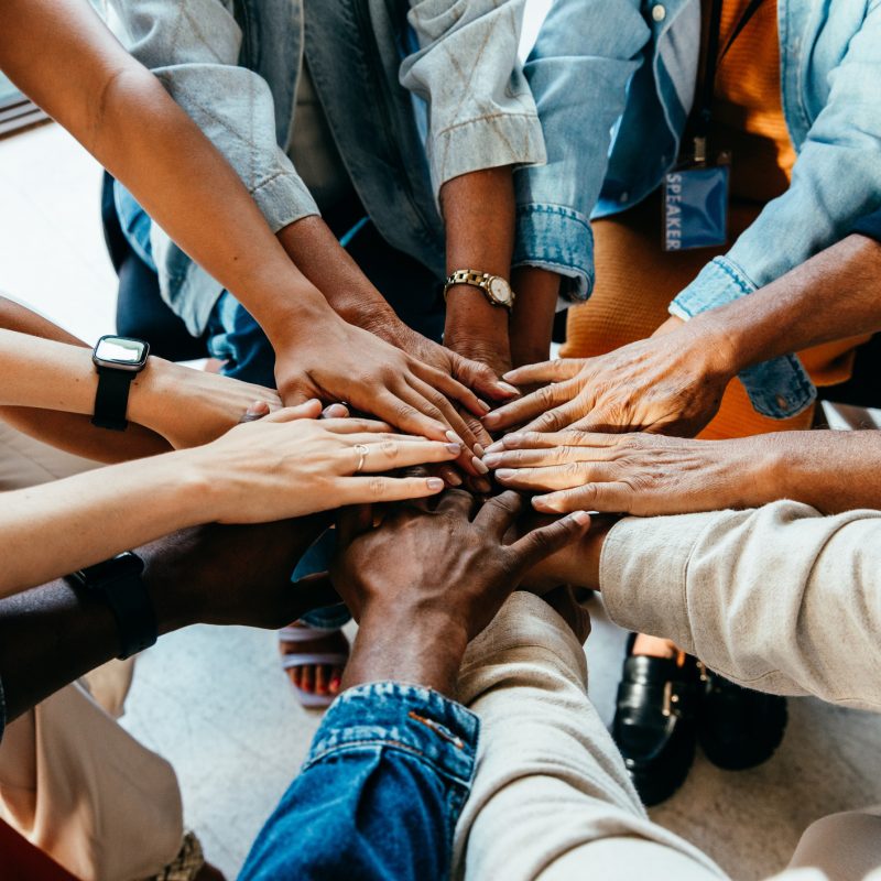 Teamwork concept with diverse hands joining together, symbolizing unity, cooperation, and collaboration stock photo