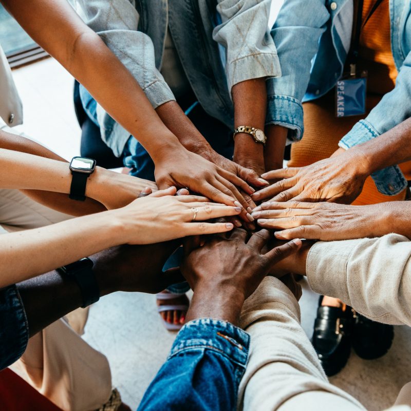 Teamwork concept with diverse hands joining together, symbolizing unity, cooperation, and collaboration stock photo